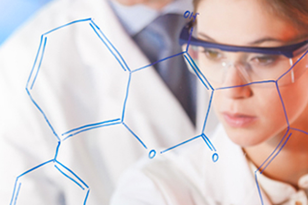 Female Scientist with lab glasses looking at data